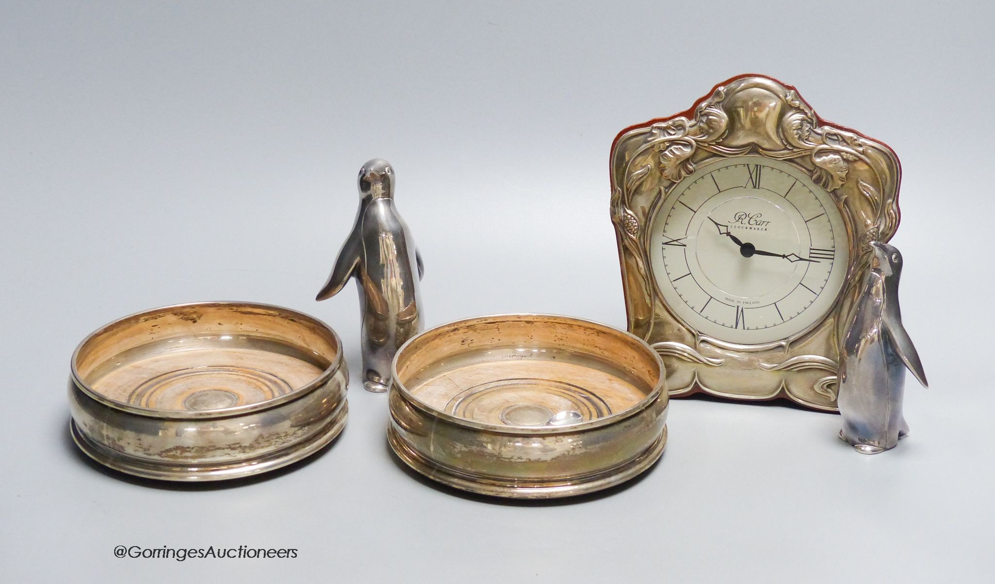A small R. Carr silver mounted mantel clock, modern, a pair of silver coasters, JB Ld, London 1996, 12.5cm, two Italian penguin ornaments, stamped 990 and a similar 800 standard spoon